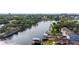 Aerial view of a waterway with docks and boats surrounded by lush greenery and homes at 1110 W Coral St, Tampa, FL 33602