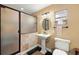 Bathroom with updated pedestal sink, toilet, and tile surround shower at 1110 W Coral St, Tampa, FL 33602