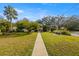 Well-manicured front yard with mature trees and a sidewalk leading to the house at 1110 W Coral St, Tampa, FL 33602