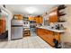Kitchen with wood cabinets, stainless steel appliances, and tile floor at 1110 W Coral St, Tampa, FL 33602