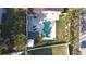 Aerial view of the backyard featuring a pool, shed, lounge chairs, and a lush lawn at 1600 Pennsylvania Ne Ave, St Petersburg, FL 33703