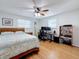 Bedroom featuring a bed, desk, and shelving with wood floors and natural light at 1600 Pennsylvania Ne Ave, St Petersburg, FL 33703