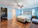 Bright bedroom featuring a walk-in closet, a bathroom, and attractive wood flooring at 1600 Pennsylvania Ne Ave, St Petersburg, FL 33703