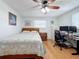 Comfortable bedroom features a ceiling fan, natural light, and an adjacent desk area at 1600 Pennsylvania Ne Ave, St Petersburg, FL 33703