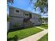 Inviting exterior with landscaped yard, features a traditional stucco facade, fenced yard, and cozy entryway at 1600 Pennsylvania Ne Ave, St Petersburg, FL 33703