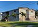 Attractive exterior elevation showcases a gray stucco and stone exterior, attached garage, and well maintained landscaping at 1600 Pennsylvania Ne Ave, St Petersburg, FL 33703