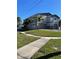 Beautiful exterior elevation with manicured front lawn, attached garage, and sidewalk at 1600 Pennsylvania Ne Ave, St Petersburg, FL 33703