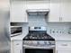Close-up of the updated kitchen featuring a stainless steel gas range and oven at 1600 Pennsylvania Ne Ave, St Petersburg, FL 33703