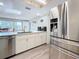 Spacious kitchen with granite counters and stainless steel appliances, including a refrigerator with dispenser at 1600 Pennsylvania Ne Ave, St Petersburg, FL 33703