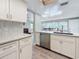 Open kitchen layout with stainless steel appliances and views into the dining area at 1600 Pennsylvania Ne Ave, St Petersburg, FL 33703