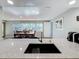 Kitchen with granite counters overlooking a dining area with large windows at 1600 Pennsylvania Ne Ave, St Petersburg, FL 33703