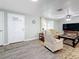 Inviting living area with a comfortable seating, wood-look floors, and bright, refreshing paint at 1600 Pennsylvania Ne Ave, St Petersburg, FL 33703