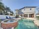 Relaxing backyard featuring a pool, hot tub, outdoor seating, and access to the upper level at 1600 Pennsylvania Ne Ave, St Petersburg, FL 33703