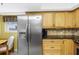 The kitchen features stainless steel appliances and light wood cabinets at 17980 Gulf Blvd # 501, Redington Shores, FL 33708