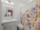 Bathroom with decorative glass sink, decorative shower curtain, and neutral wall paint at 320 N Madison Ave, Clearwater, FL 33755