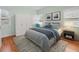 Neutral bedroom with a queen bed, dark wood flooring, and ample natural light at 320 N Madison Ave, Clearwater, FL 33755