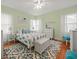 Bright bedroom with white furniture, an area rug, and natural light from surrounding windows at 320 N Madison Ave, Clearwater, FL 33755