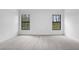 Carpeted bedroom featuring a view of the outside landscape from two windows at 3355 Moncrief Ave, North Port, FL 34286