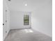 Bedroom with neutral carpet, trim, and a view of nature from the window at 3355 Moncrief Ave, North Port, FL 34286