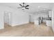 Open-concept living room and kitchen with stainless steel appliances and tile flooring at 3355 Moncrief Ave, North Port, FL 34286