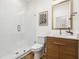 Modern bathroom features include walk-in shower, wood cabinets, and decorative wall art at 460 87Th Avenue North, St Petersburg, FL 33702