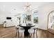 Open floor plan with dining area features modern decor, hardwood floors, and large windows at 460 87Th Avenue North, St Petersburg, FL 33702