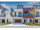 Modern townhouse exterior with spiral staircase, garage, and well manicured tropical landscaping at 460 87Th Avenue North, St Petersburg, FL 33702