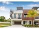 Contemporary townhome showcasing a rooftop deck, spiral staircase, wood accents, and clean landscaping at 460 87Th Avenue North, St Petersburg, FL 33702