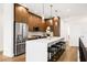 Modern kitchen features wooden cabinets, stainless steel appliances, a large island, and stylish pendant lighting at 460 87Th Avenue North, St Petersburg, FL 33702