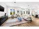 Bright living room with large windows, hardwood floors, and a stylish area rug at 460 87Th Avenue North, St Petersburg, FL 33702