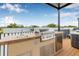 This rooftop gourmet kitchen area includes stainless steel cabinets, and a grill under a pergola at 460 87Th Avenue North, St Petersburg, FL 33702