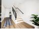 Bright home entryway with wooden floors, staircase, and modern decor at 484 87Th Avenue North, St Petersburg, FL 33702