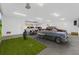 Spacious garage with multiple cars, a golf setup, and a wall-mounted entertainment system at 484 87Th Avenue North, St Petersburg, FL 33702