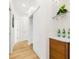 Bright hallway with wood flooring, a cabinet, and storage behind sliding doors at 484 87Th Avenue North, St Petersburg, FL 33702