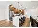 Modern kitchen featuring a large island with barstool seating, pendant lighting and stainless steel appliances at 484 87Th Avenue North, St Petersburg, FL 33702