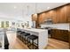 Open-concept kitchen with modern cabinetry, a waterfall island, and stainless steel appliances at 484 87Th Avenue North, St Petersburg, FL 33702