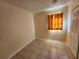 Empty room with tile flooring, neutral walls, and a window with a curtain at 5209 10Th S Ave, Gulfport, FL 33707