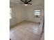 White bedroom with tile flooring, two windows, and an air conditioner at 5209 10Th S Ave, Gulfport, FL 33707