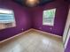 Purple bedroom with tile flooring and two windows for natural light at 5209 10Th S Ave, Gulfport, FL 33707