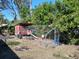 A secure chicken coop surrounded by green foliage, providing a safe outdoor space for poultry at 5209 10Th S Ave, Gulfport, FL 33707
