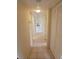 Tiled hallway with storage closet leads to the rooms of the house at 5209 10Th S Ave, Gulfport, FL 33707