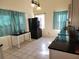 A bright kitchen with black refrigerator, curtains and adjacent eat-in area at 5209 10Th S Ave, Gulfport, FL 33707