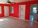 Sunlit living room boasts neutral tile, front door, and view into kitchen at 5209 10Th S Ave, Gulfport, FL 33707