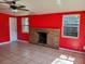 A brightly colored living room featuring a brick fireplace, tile floors and natural light at 5209 10Th S Ave, Gulfport, FL 33707