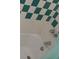Close up of a shower with chrome fixtures and white and green diamond-patterned tiling at 5209 10Th S Ave, Gulfport, FL 33707