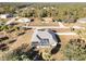 Aerial view of house with screened pool surrounded by trees in neighborhood at 5366 Hader Rd, North Port, FL 34288
