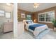 Cozy bedroom with en-suite bathroom, featuring a full sized bed, tile floors, walk-in closet and one window at 5366 Hader Rd, North Port, FL 34288