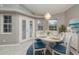 Dining room with white oval table and blue accents, highlighted by a modern chandelier and bright natural light at 5366 Hader Rd, North Port, FL 34288