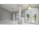 Spacious entryway with tile flooring, a support column, a ceiling fan, and double doors to let in ample natural light at 5366 Hader Rd, North Port, FL 34288