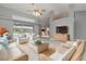 Open living room with rattan furniture, tile floors, vaulted ceilings, and a view of the screened-in pool at 5366 Hader Rd, North Port, FL 34288